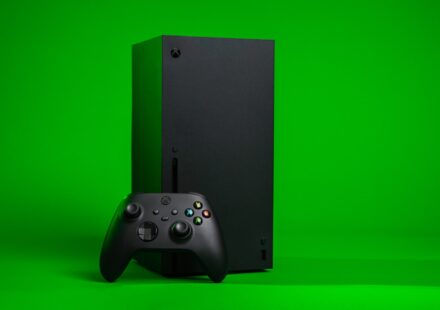 black xbox one console with controller