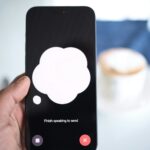 a person holding a cell phone with a speech bubble on the screen