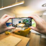 A person taking a picture with a cell phone