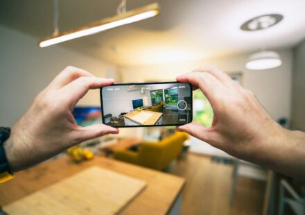 A person taking a picture with a cell phone