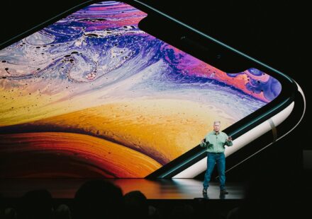 man in white shirt and blue denim jeans standing on blue and yellow water