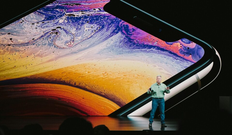 man in white shirt and blue denim jeans standing on blue and yellow water