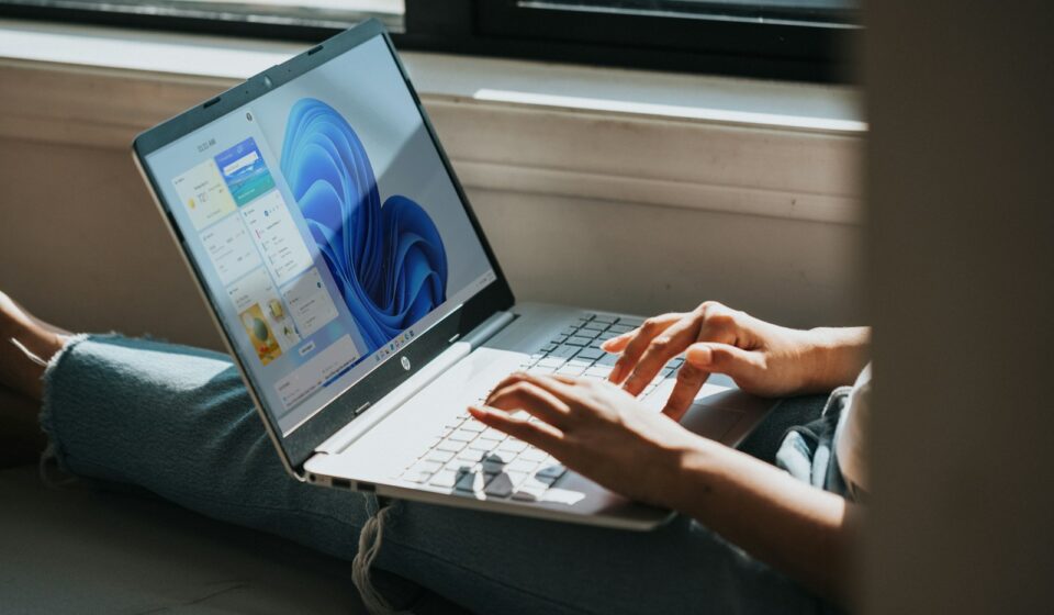 person using Windows 11 computer on lap