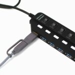 Black usb hub with multiple ports and switches.