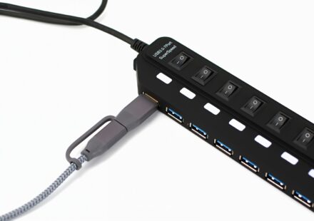 Black usb hub with multiple ports and switches.