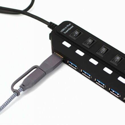 Black usb hub with multiple ports and switches.