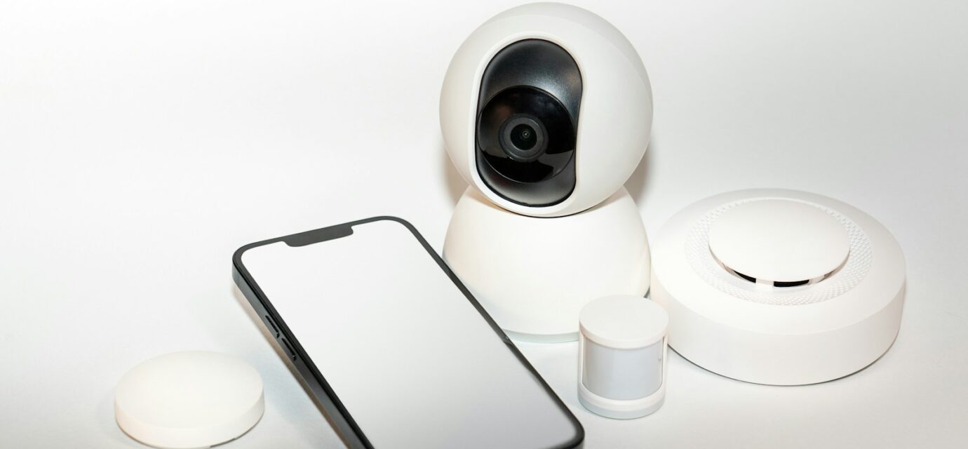 a smart phone sitting next to a security camera