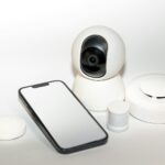 a smart phone sitting next to a security camera