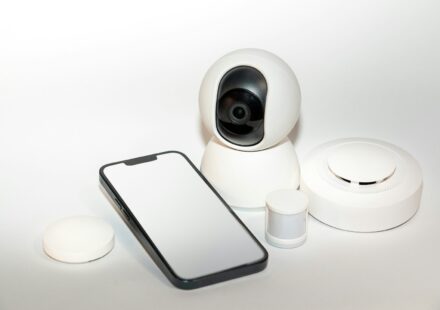a smart phone sitting next to a security camera