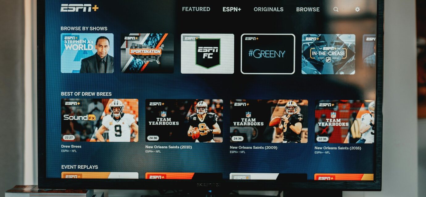 a flat screen tv sitting on top of a wooden table