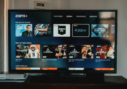 a flat screen tv sitting on top of a wooden table