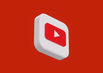 a red and white play button on a red background