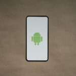 a cell phone with a green icon on it