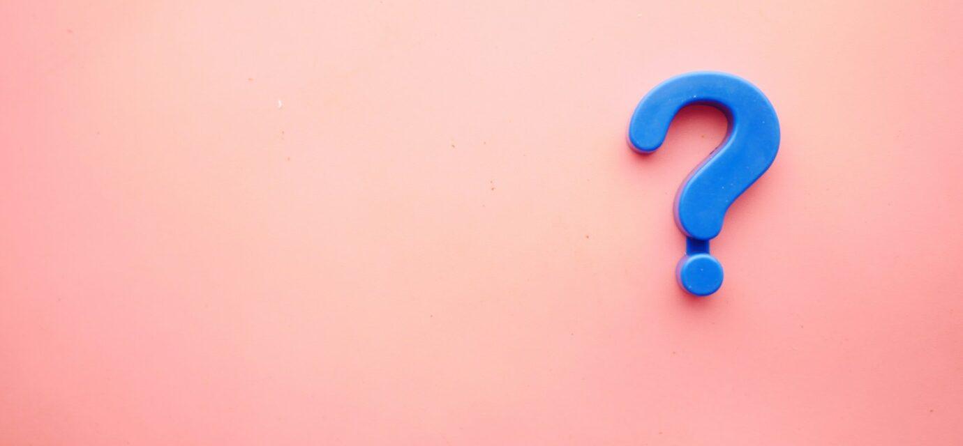 a blue question mark on a pink background