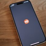 A cell phone sitting on top of a wooden table