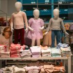 Clothing display with child mannequins at a store.