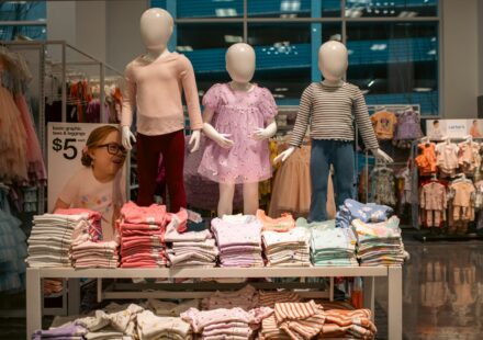 Clothing display with child mannequins at a store.