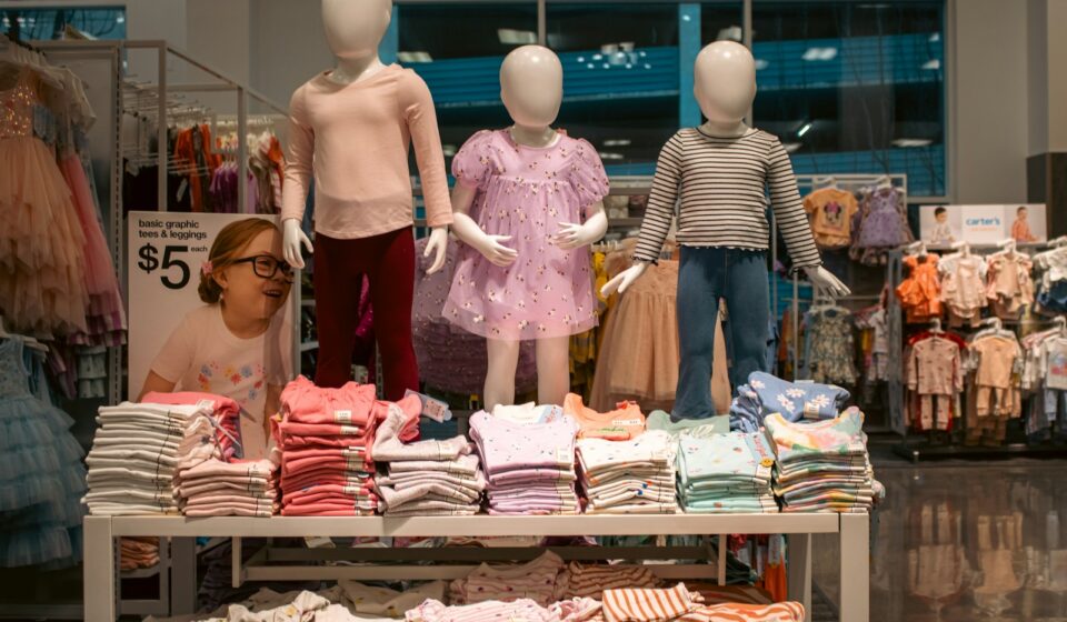 Clothing display with child mannequins at a store.