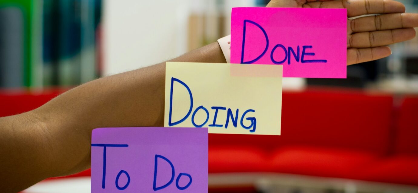 person holding purple and pink box