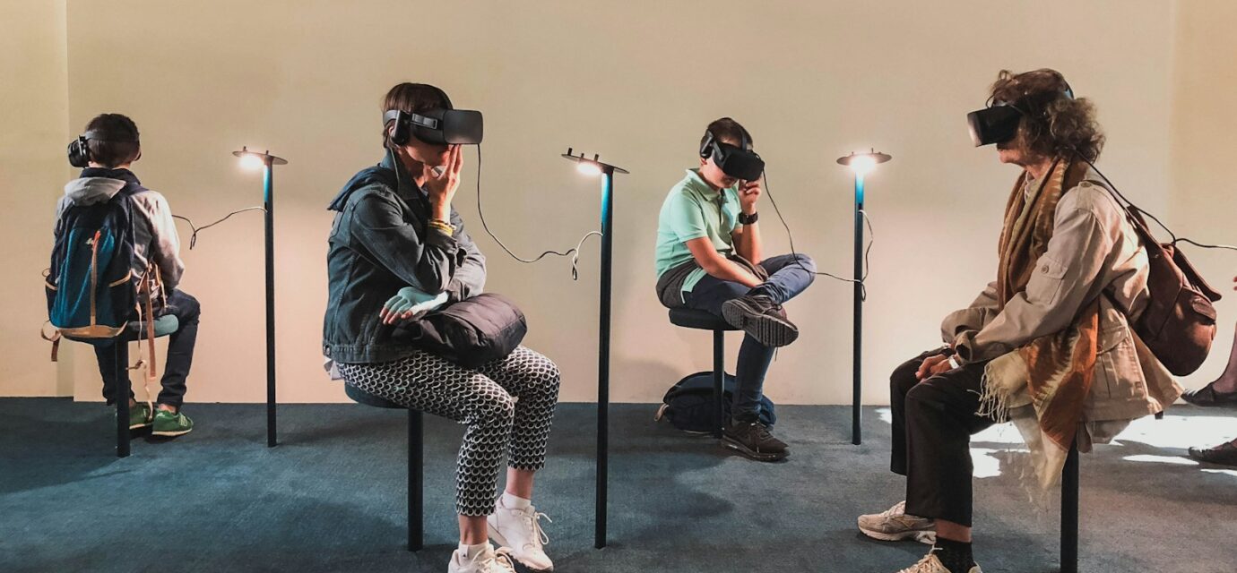 four person playing virtual reality goggles