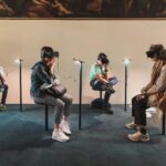 four person playing virtual reality goggles