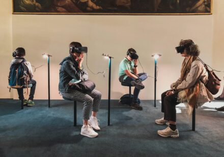 four person playing virtual reality goggles