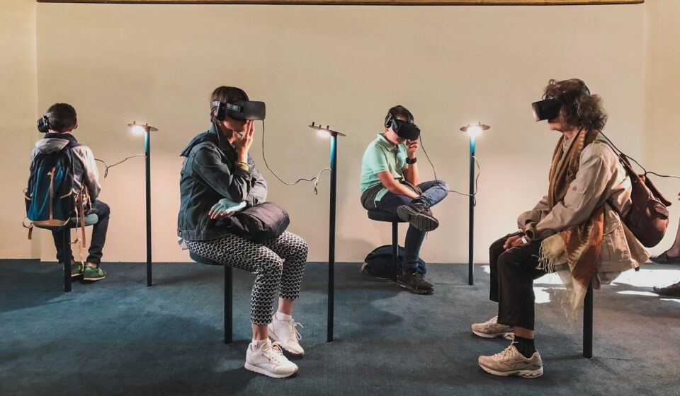 four person playing virtual reality goggles