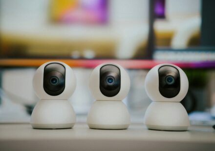 Three small white cameras sitting on top of a table
