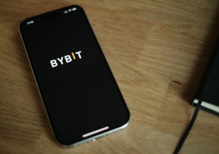 A cell phone sitting on top of a wooden table
